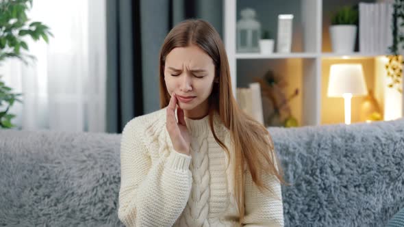 Woman Suffering From Toothache on Couch