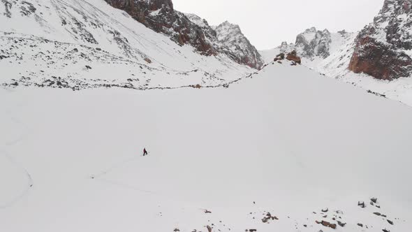 Aerial Shot of Man Ski Touring in Winter Glacier Mountains