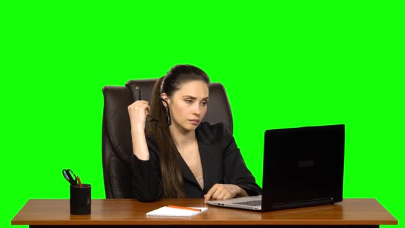 Tired Girl with Glasses in Her Hands Works at a Laptop, Then Rubs Her Eyes. Green Screen
