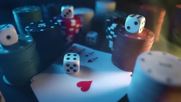 Casino Chips with Dice and Playing Cards on a Dark Table