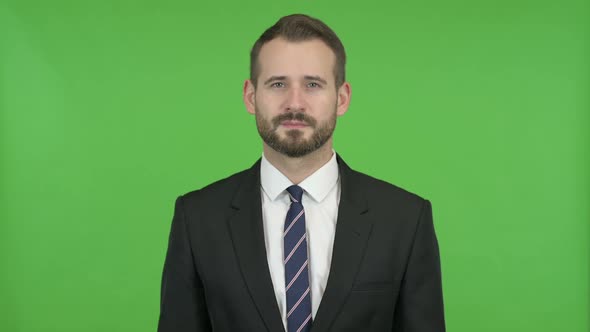 Ambitious Businessman Showing Victory Sign Against Chroma Key