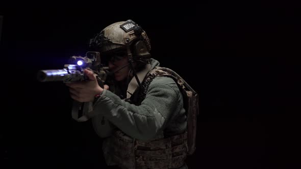 US Special Forces Soldier Aiming with Rifle at Night in Darkness