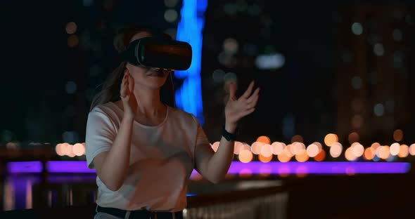 Young Girl in Virtual Reality Glasses in a Big Metropolis