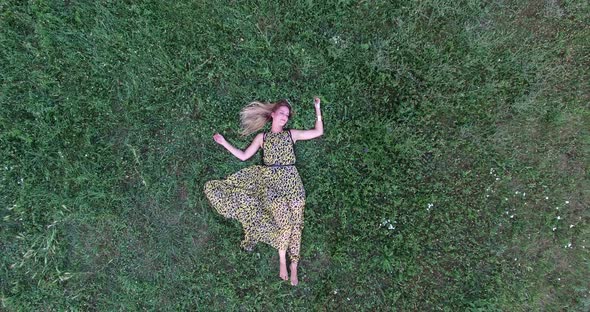 Young woman lying in grass