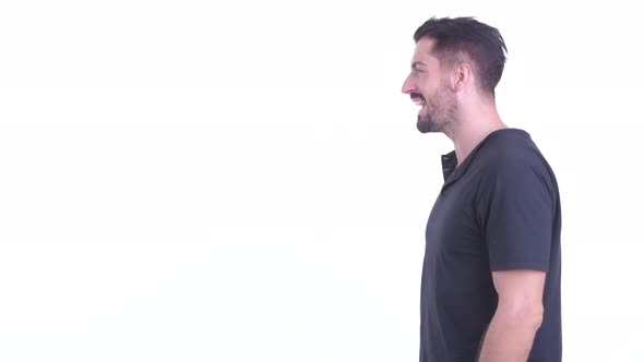 Profile View of Happy Young Handsome Bearded Man Talking