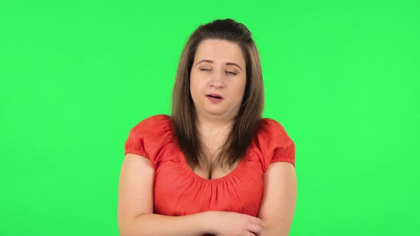 Portrait of Cute Girl Listening To Boring Information and Yawning. Green Screen