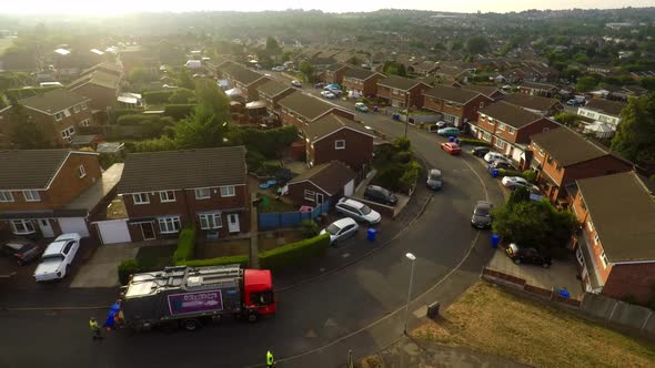 Aerial View, footage of Dustmen putting recycling waste into a garbage truck, Bin men, refuse collec