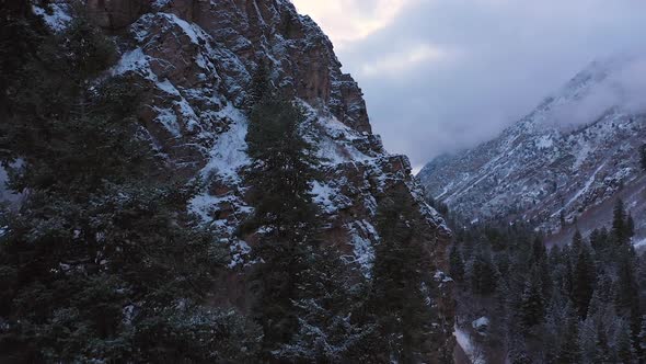 Rising aerial view of rugged terrain in snowy canyon