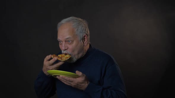 Glad Pensioner Chews Pizza Holding Green Plate in Hand