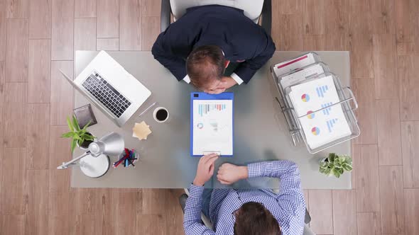 Top View of Businessman in Suit Shaking Hands with a Manager