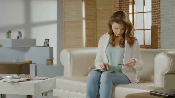 Young Woman Shopping Online, Using Banking Service on Tablet PC