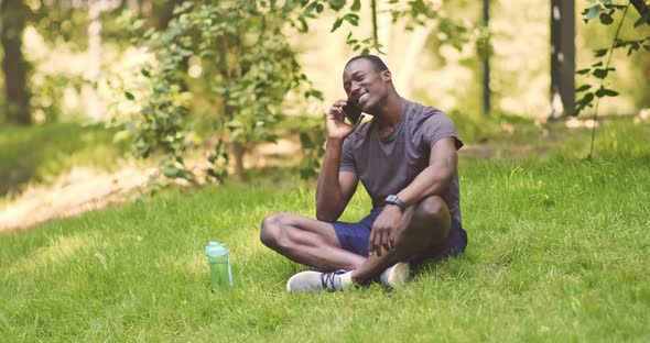 Cheerful African American Guy Talking on Cellphone