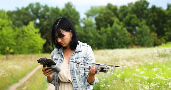 Young woman learning how to pilot her drone in, female using, piloting