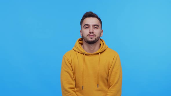 Expressive young man screaming and shouting over vibrant background.