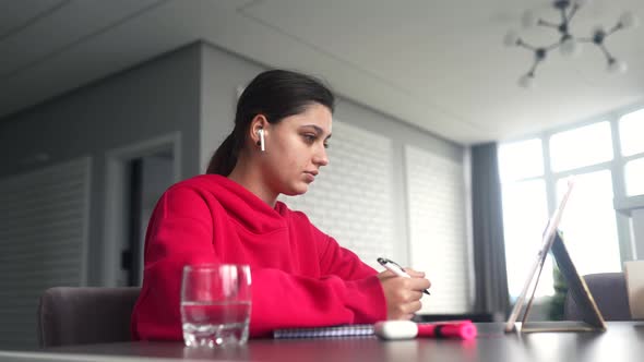 Beautiful Caucasian Female Student is Studying in College Remotely