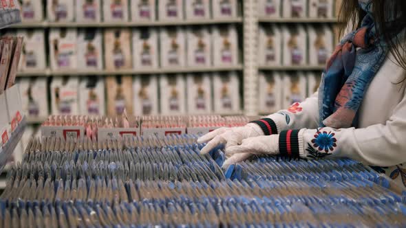 Woman in Rubber Gloves Choosing Nylon Tights