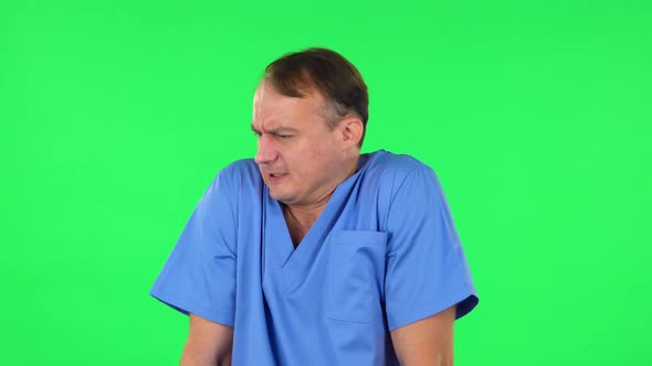 Medical Man Froze and Trying To Keep Warm Against Green Screen.