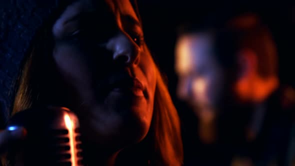 Close-up of female singer singing in studio