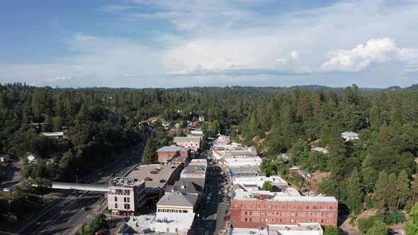 Wide reverse pullback aerial shot of the historical mining town Placerville. 4K