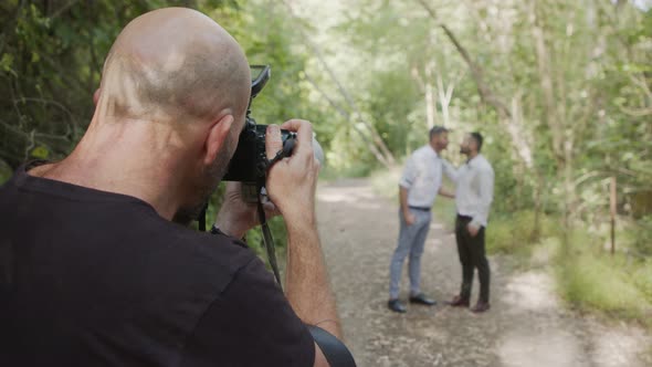 Gay couple during a photo shoot before their wedding in a forest