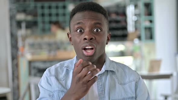 Portrait of Worried Young African Man Feeling Shocked