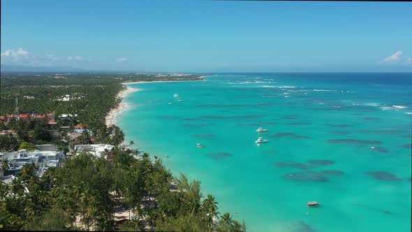 Tropical Beach with Resorts Palm Trees and Caribbean Sea