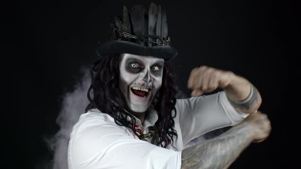 Creepy Man with Skeleton Halloween Makeup in Bloody Shirt. Guy Listening Music, Dancing, Celebrating