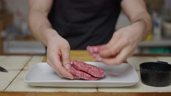 Detail Shot of Hands Separating Burgers in White Tray in Slow Motion