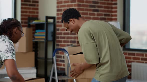 African American Couple Using Cardboard Boxes to Move in