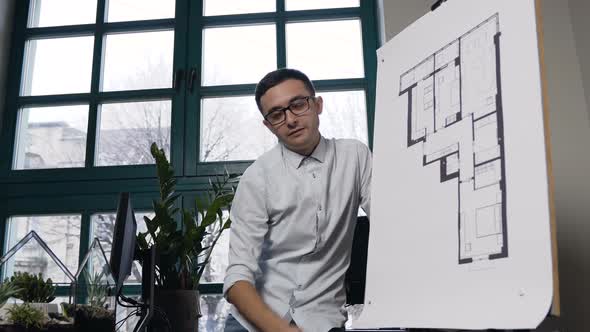 Attractive Young Architect Creating Building Plans of New Project in the Modern Office