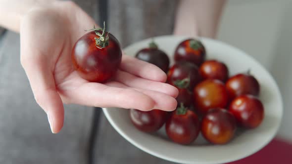 Juicy Ripe Black Cocktail Tomatoes on the Plate