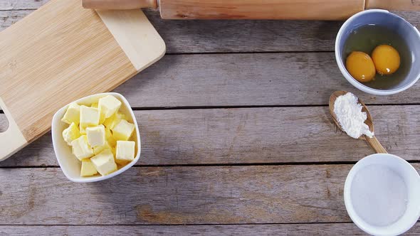 Butter cubes and egg yolk on a wooden table 4k