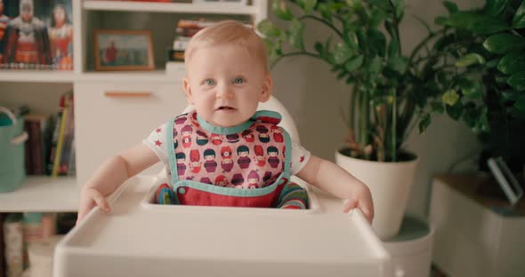 Cute Baby Girl Waiting In High Chair