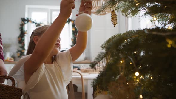 Father and daughter decorating the Christmas tree. Shot with RED helium camera in 8K