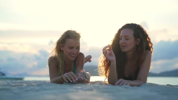 Playful Models Picking Up Seashells in Koh Tean Beach