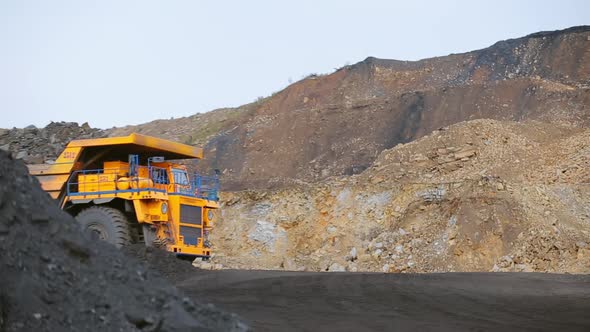 Heavy Coal-laden Dump Truck Leaves on the Road