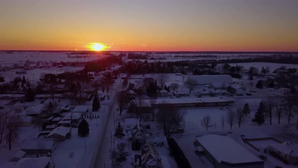 Cinematic drone view over a small town in the winter