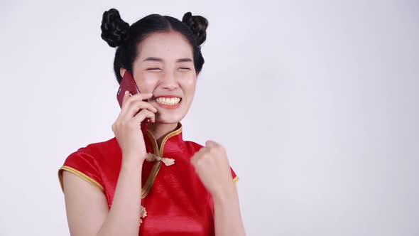 happy woman wear cheongsam and using mobile phone