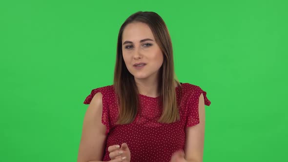 Portrait of Tender Girl in Red Dress Is Smiling and Blowing Kiss. Green Screen