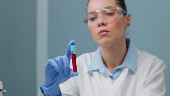 Microbiology Doctor Studying Vacutainer with Liquid Blood