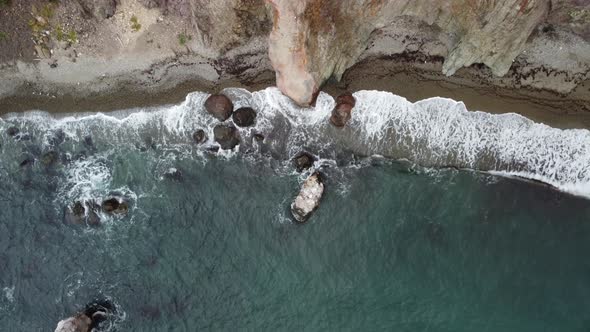 Aerial View From Above on Calm Azure Sea and Volcanic Rocky Shores