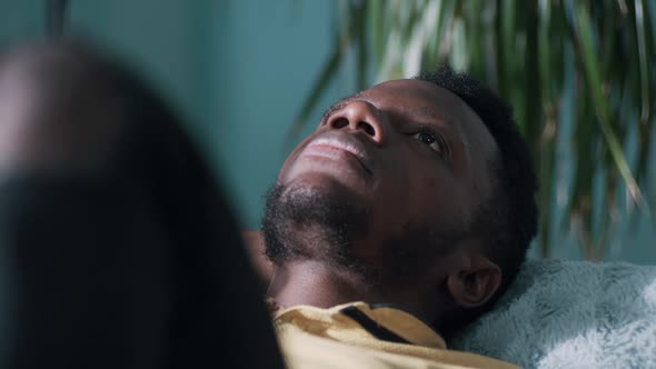 Depressed Black Male Resting on Sofa