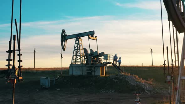 Engineers Are Having a Conversation at the Oil Pumping Site