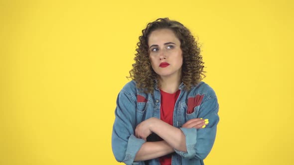 Girl Is Angry, Waving Her Hands in Indignation, Shrugs on Yellow Background at Studio, Slow Motion