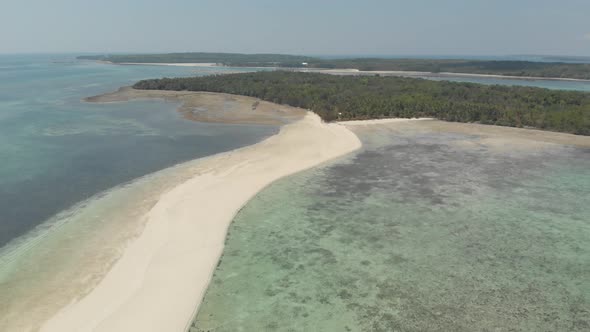 Aerial: tropical beach island reef caribbean sea white sand bar Snake Island, Indonesia Maluku