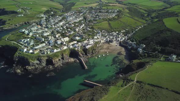 A Small Fishing Village At Port Isaac Surrounded By The Lush Green Fields And Meadow On A Bright Day