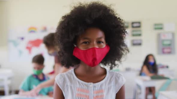 Portrait of boy wearing face mask in class at school