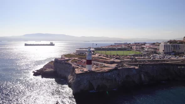 Aerial Rising View Of Europa Point With scenic Strait of Gibraltar In Background On Sunny Day