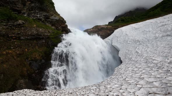 High Cascade Waterfall Falling in Snowball