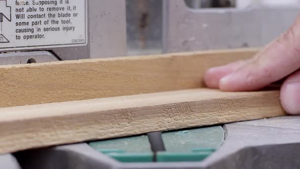 Close up view of miter saw cutting a board and an angle